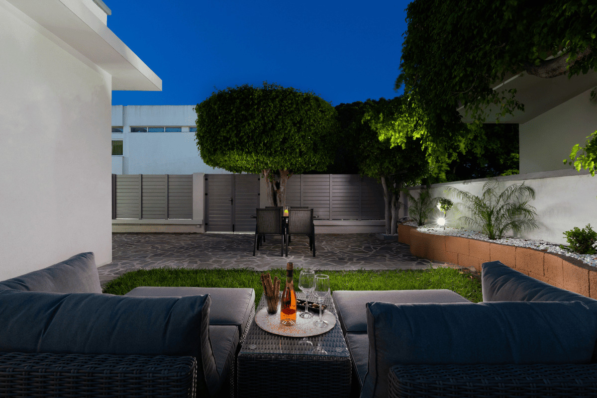 Modern apartment exterior with garden lighting at night in Duo Verde Rhodes